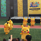 Illustration for article titled Rapidly Deflating Pikachu Rushed To Safety By Small Horde Of Suited Men